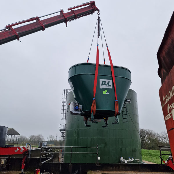 Mini crane lifting a heavy farm machine