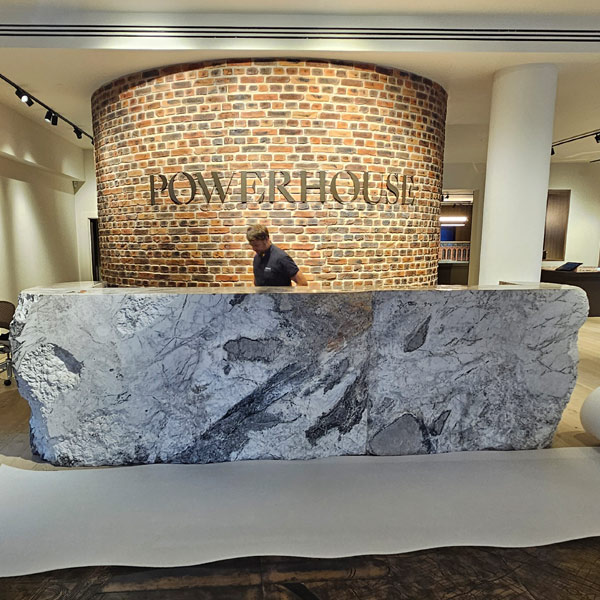 2900kg multi-piece marble reception desk at Lots Road Chelsea before disassembly