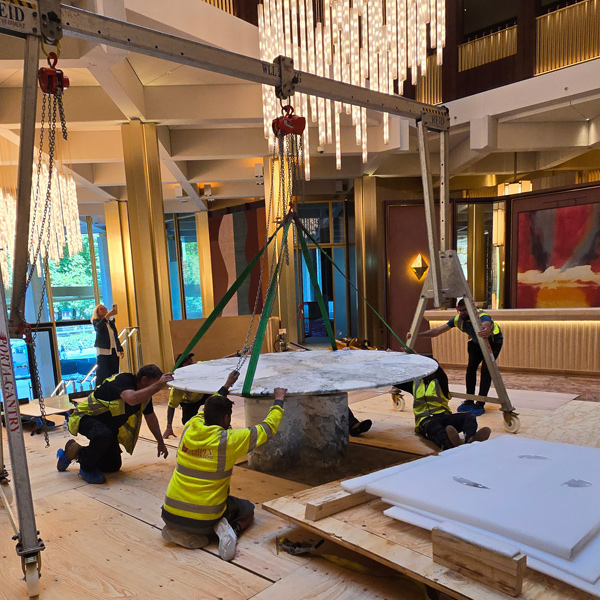 Specialist team moving a heavy unit on stairs with controlled handling