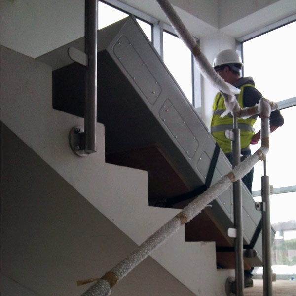Heavy bank vault door being removed.