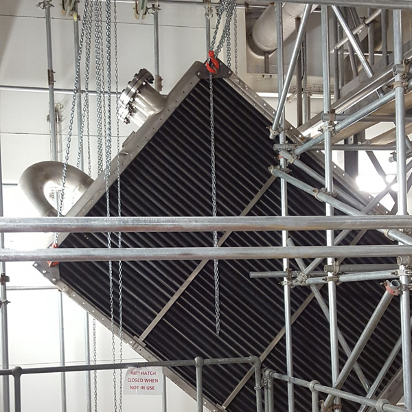 Restricted-access internal lift of a heat exchanger in a food factory